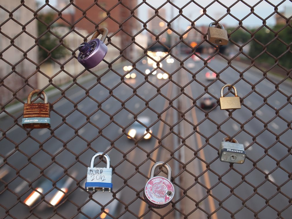 Bridge over the Mass Pike near BU with locks on chainlink fence